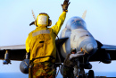 Navy Sailor Directing an F-18 Hornet